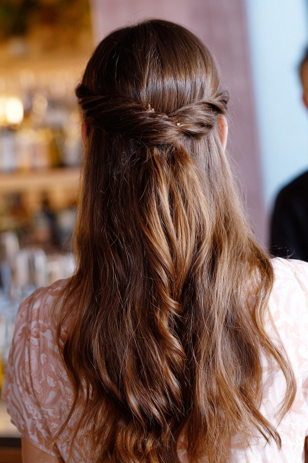 12. Haartrends 2026: Half-Up Twist mit seidigen Wellen und feiner Haarspange