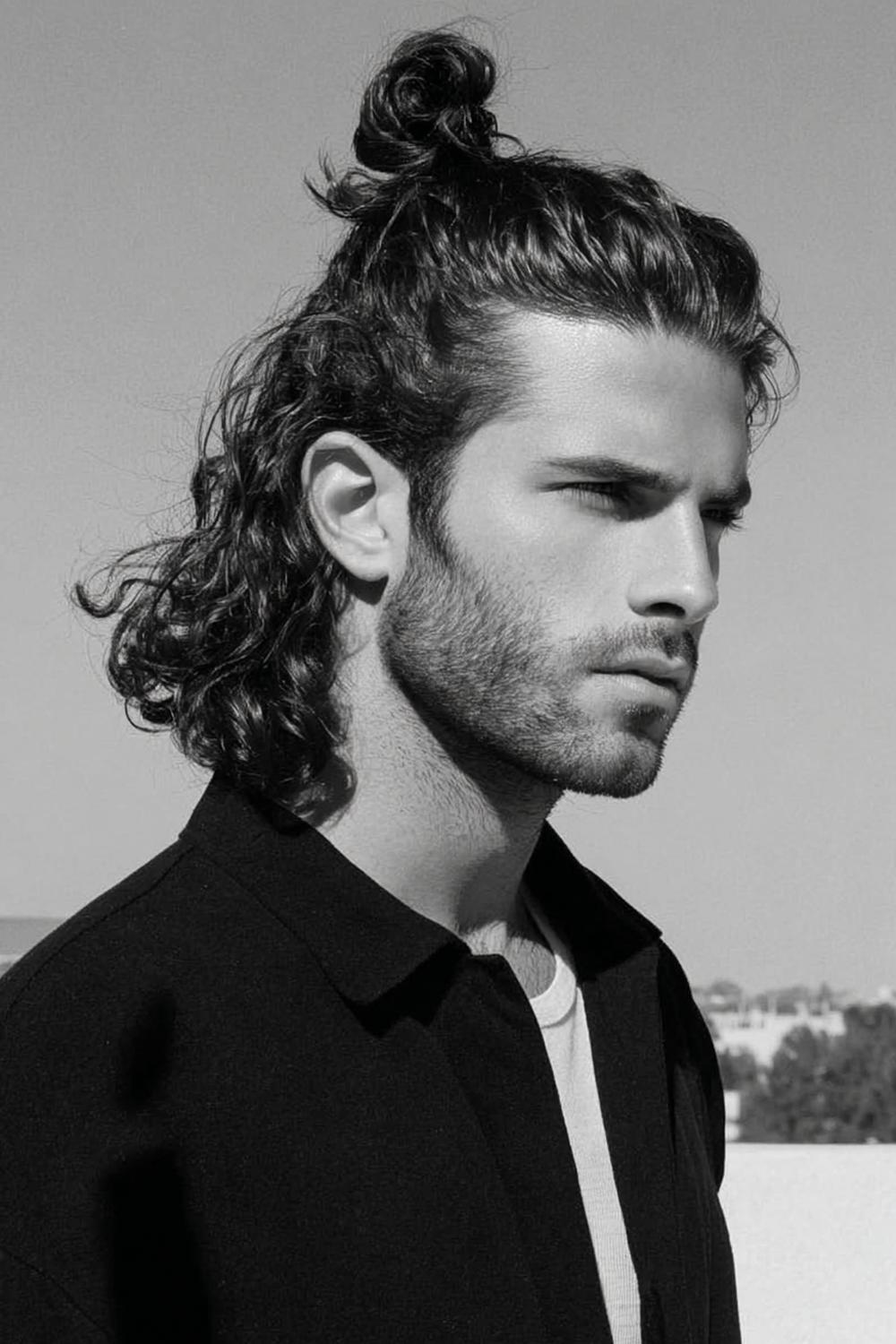 25. Männer Frisuren 2026: Half-Up Top Knot mit offenen Längen und texturierten Spitzen